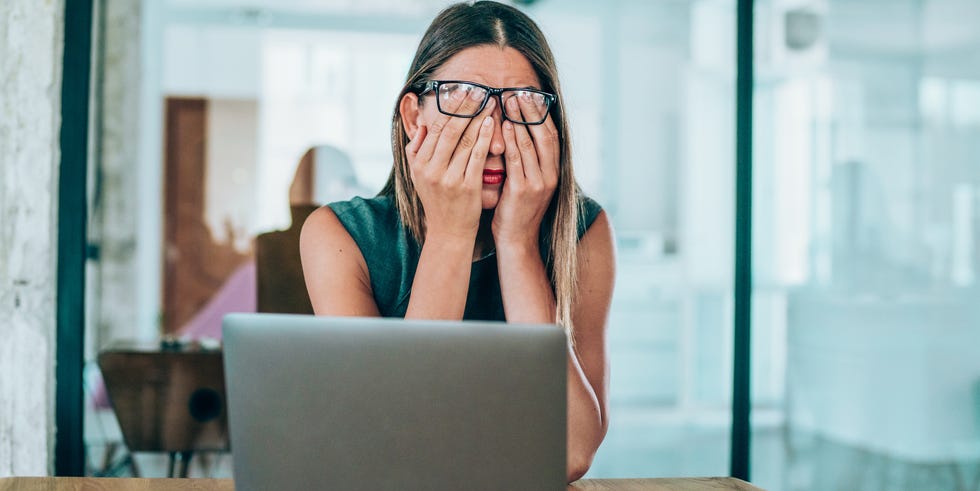 female-entrepreneur-with-headache-sitting-at-desk-royalty-free-image-1617378552_.jpg