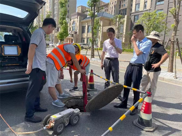 圖一 該大隊技術人員在柴桑區六小門口開展雨水管網排查溯源工作.jpg